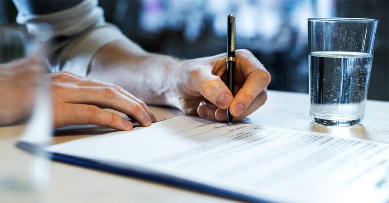 person signing a legal document GettyImages 1192652889 1200w 628h